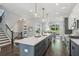 A modern kitchen island featuring barstool seating and views of the dining room and staircase at , Atlanta, GA 30310