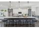 Contemporary kitchen features an oversized island with barstools and pendant lighting at , Atlanta, GA 30310