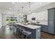 Bright kitchen with an island, white cabinets, stainless steel appliances, and modern lighting at , Atlanta, GA 30310