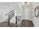 Entryway staircase with dark wood railings and white walls at , Atlanta, GA 30310