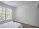 Bright bedroom with natural light, neutral walls, and comfortable bedding at 200 Renaissance Ne Pkwy # 219, Atlanta, GA 30308