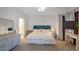 Bright bedroom featuring a tufted headboard, white bedding, and a dedicated desk area at 200 Renaissance Ne Pkwy # 219, Atlanta, GA 30308