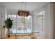 Elegant dining area features modern chandelier, ample natural light, and sheer window treatments at 200 Renaissance Ne Pkwy # 219, Atlanta, GA 30308