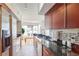 Sleek kitchen boasts stainless appliances, dark counters, and cherry wood cabinets with access to dining area at 200 Renaissance Ne Pkwy # 219, Atlanta, GA 30308