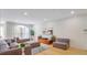 Inviting living room featuring a large window, hardwood flooring, and contemporary decor at 200 Renaissance Ne Pkwy # 219, Atlanta, GA 30308