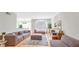 Bright living room with hardwood floors, modern furnishings, and large windows for natural light at 200 Renaissance Ne Pkwy # 219, Atlanta, GA 30308