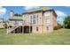 Rear exterior view of home showing deck, patio and spacious yard at 2032 Grovewood Ct, Cumming, GA 30041