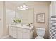 Bright bathroom with a white vanity, framed mirror, and a striped shower curtain adds a fresh touch at 2032 Grovewood Ct, Cumming, GA 30041