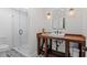 Stylish bathroom features a glass shower, wood vanity, and patterned tile floor at 2032 Grovewood Ct, Cumming, GA 30041