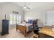 Cozy bedroom featuring a wood-framed bed, ceiling fan, and window with shutter, creating a relaxing space at 2032 Grovewood Ct, Cumming, GA 30041
