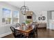 Charming dining room with a wood table, chandelier, and natural light, creating a welcoming atmosphere at 2032 Grovewood Ct, Cumming, GA 30041