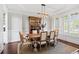 Elegant dining room featuring a wooden table, stylish chairs, modern chandelier, and sophisticated decor at 2032 Grovewood Ct, Cumming, GA 30041
