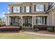 Charming brick home with inviting front porch and manicured landscaping at 2032 Grovewood Ct, Cumming, GA 30041