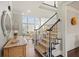 Grand foyer with staircase, abundant natural light, and elegant decor creates a welcoming entrance at 2032 Grovewood Ct, Cumming, GA 30041