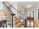Classic foyer with staircase, double doors, and stylish decor sets a sophisticated tone at 2032 Grovewood Ct, Cumming, GA 30041