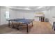 Basement game room featuring a ping pong table, wood floors, and a wet bar, for entertainment at 2032 Grovewood Ct, Cumming, GA 30041