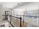 Bright hallway featuring hardwood floors, white railings, and arch windows provides an airy feel at 2032 Grovewood Ct, Cumming, GA 30041