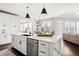 Bright, modern kitchen with white cabinets, stainless steel appliances, and a center island with room for seating at 2032 Grovewood Ct, Cumming, GA 30041