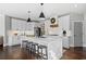 Modern kitchen features white cabinets, stainless steel appliances, large island with breakfast bar, and pendant lighting at 2032 Grovewood Ct, Cumming, GA 30041