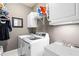 Functional laundry room with modern washer and dryer, storage cabinets, and a utility sink at 2032 Grovewood Ct, Cumming, GA 30041