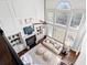 Bright two-story living room with a fireplace, large windows, hardwood floors, and stylish decor at 2032 Grovewood Ct, Cumming, GA 30041