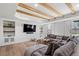 Modern living room with wooden beams, a large gray couch, and custom built-ins offers a comfortable space at 2032 Grovewood Ct, Cumming, GA 30041
