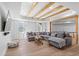 Bright living room boasts exposed beams, hardwood floors, and comfortable seating at 2032 Grovewood Ct, Cumming, GA 30041