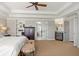 Spacious main bedroom showcasing a doorway to the main bath, carpeted floors, and neutral walls at 2032 Grovewood Ct, Cumming, GA 30041