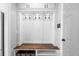 Clean mudroom offers coat hooks, overhead lighting, and storage for organization near the entrance at 2032 Grovewood Ct, Cumming, GA 30041
