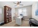 Bright office space with a built-in bookcase, a ceiling fan, and a white office desk at 2032 Grovewood Ct, Cumming, GA 30041