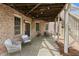 Covered outdoor patio with seating offers a relaxing space at 2032 Grovewood Ct, Cumming, GA 30041
