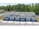 Aerial view showcasing the townhome exteriors with garages, landscaping, and street access at 2413 Malster Ln, Lawrenceville, GA 30043