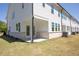 Backyard featuring a concrete patio, white siding, and a small grass yard at 2413 Malster Ln, Lawrenceville, GA 30043