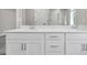 Elegant bathroom featuring double vanity with white cabinets and a glass-enclosed shower at 2413 Malster Ln, Lawrenceville, GA 30043