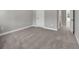 A bedroom featuring neutral carpet, white trim, and doors leading to other rooms at 2413 Malster Ln, Lawrenceville, GA 30043