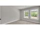 Bedroom featuring neutral decor, plush carpet, and large windows that enhance natural light and neighborhood views at 2413 Malster Ln, Lawrenceville, GA 30043