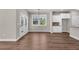 Dining area featuring hardwood floors, French doors to outside, and white cabinets in the kitchen area at 2413 Malster Ln, Lawrenceville, GA 30043