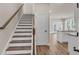 Inviting entryway with hardwood floors leading to staircase and open kitchen area at 2413 Malster Ln, Lawrenceville, GA 30043