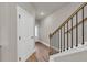 Inviting entryway with hardwood floors and staircase with decorative rod iron railings at 2413 Malster Ln, Lawrenceville, GA 30043