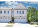 Charming townhome featuring a spacious two-car garage and beautiful, modern architectural design at 2413 Malster Ln, Lawrenceville, GA 30043