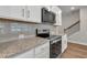 Close up of the kitchen featuring granite countertops and stainless steel appliances at 2413 Malster Ln, Lawrenceville, GA 30043