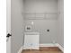 Simple laundry room design with basic utility features and modern white color palette at 2413 Malster Ln, Lawrenceville, GA 30043