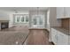 Open concept living room with a fireplace, ceiling fan, and views of the backyard at 2413 Malster Ln, Lawrenceville, GA 30043