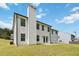 Exterior of white home features a backyard with patio and green lawn under a bright blue sky at 3791 Plantation Mill Dr, Buford, GA 30519