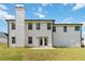 Exterior view of a home featuring a backyard with a patio, green lawn, and white siding at 3791 Plantation Mill Dr, Buford, GA 30519