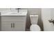 Bathroom showcases white vanity, chrome fixtures, and a white toilet at 3791 Plantation Mill Dr, Buford, GA 30519
