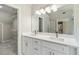 Bright bathroom boasts a dual sink vanity with white cabinets, quartz countertops and a walk-in closet at 3791 Plantation Mill Dr, Buford, GA 30519