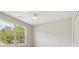 Well-lit bedroom with neutral paint features a ceiling fan, window, and a closet for ample storage at 3791 Plantation Mill Dr, Buford, GA 30519