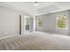 Large bedroom with tray ceiling, carpet flooring, and natural light at 3791 Plantation Mill Dr, Buford, GA 30519