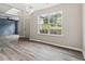 Bright dining room featuring stylish light fixtures, hardwood floors, and a large window with natural light at 3791 Plantation Mill Dr, Buford, GA 30519